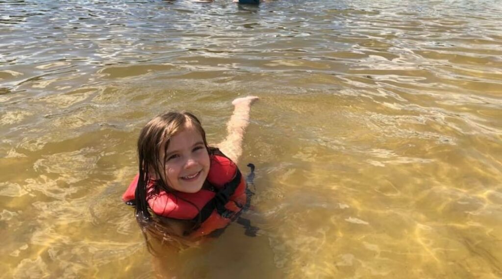 Child playing at White Sands Lake Day Beach