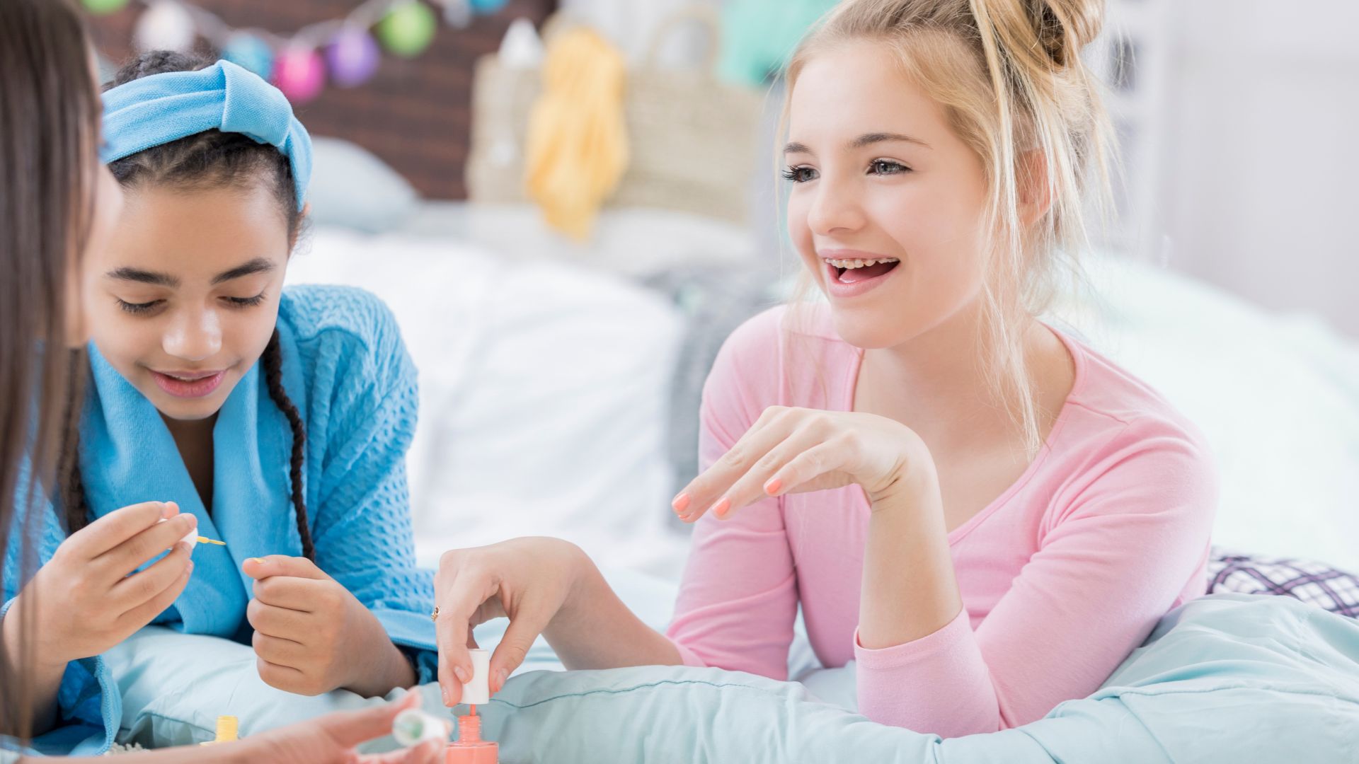 girls painting nails at a slumber party