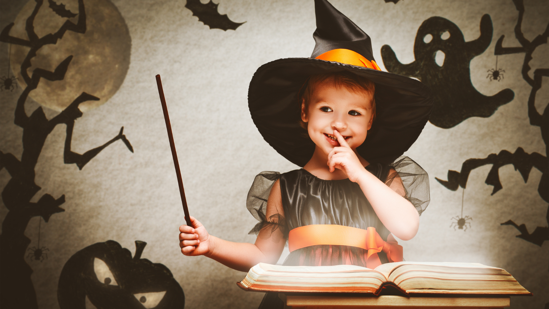 A little witch on Halloween casting a spell