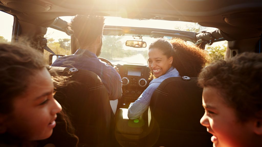 Family in a car on a road trip from New Orleans